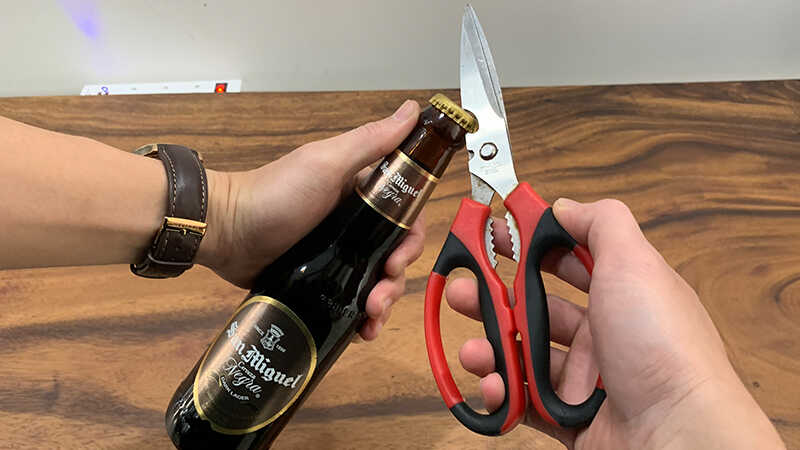 Open beer with scissors
